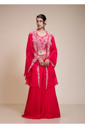 Rani pink lehenga skirt with embroidered crop top and sheer cape jacket in front full-length view