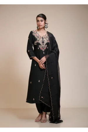 Model wearing a black gota patti kurta set with embroidered neckline, matching pants, and a black dupatta.