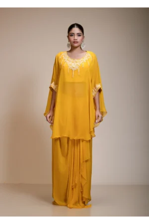 A medium side-angle view of the Mustard Yellow Kaftan Tunic showing the delicate white bead embroidery on the sleeves and neckline.