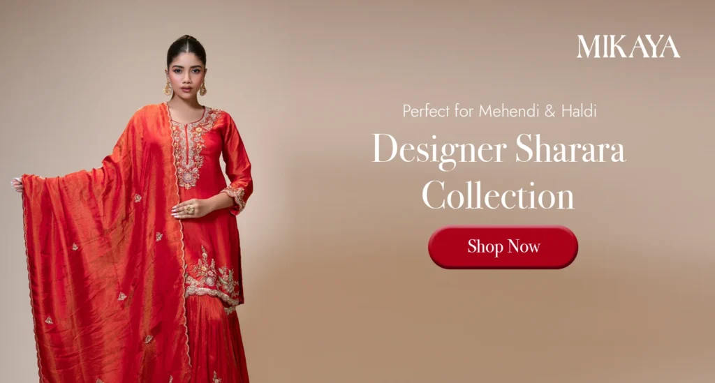 Woman wearing a designer red sharara suit with embroidered kurta and dupatta from Mikaya for Mehendi and Haldi ceremonies.